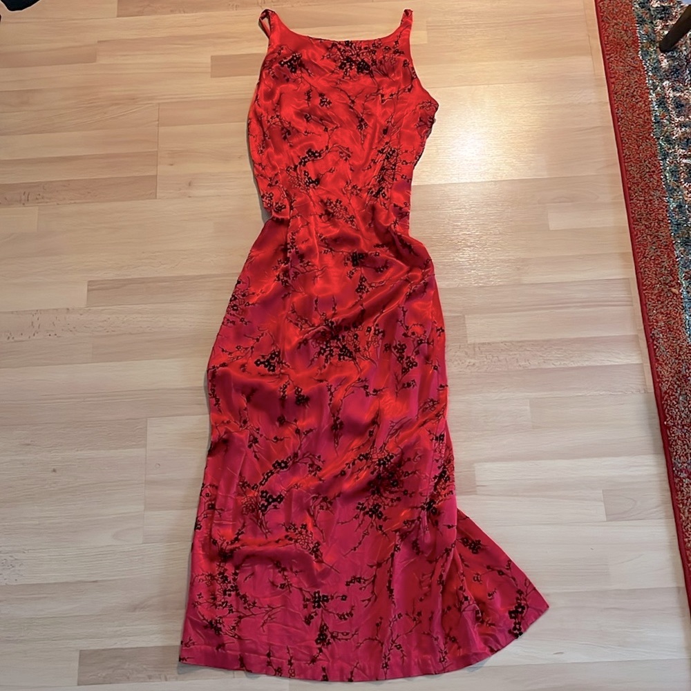 Vintage form fitting red dress, with black velvet blossom pattern.